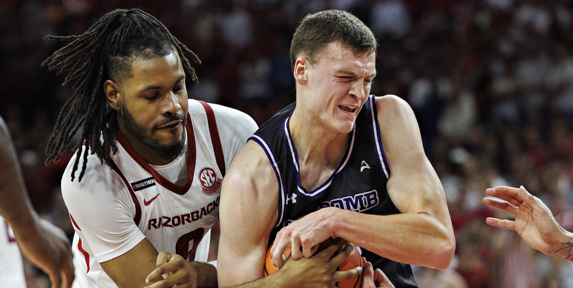 Jacob Ognacevic #41 of the Lipscomb Bison drives to the basket against Jonas Aidoo #9 of the Arkansas Razorbacks