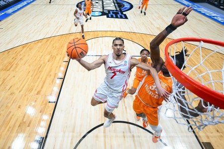 Milos Uzan of the Houston Cougars shoots the ball against Felix Okpara #34 of the Tennessee Volunteers in the Elite Eight round of the 2025 NCAA Men's Basketball Tournament